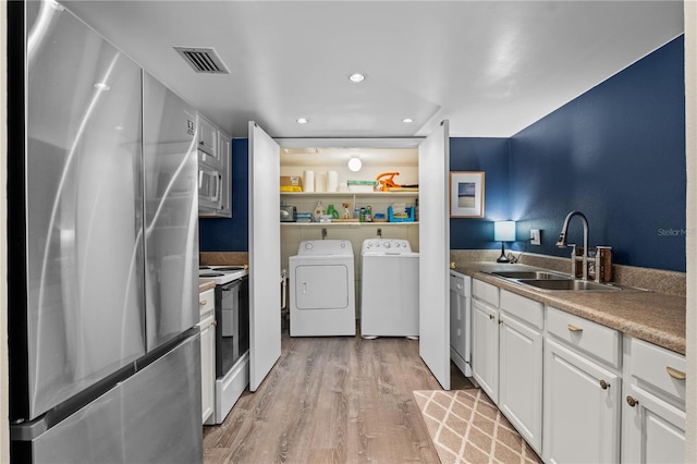 111 Crown Oaks Way Unit 101, Longwood, FL 32779 - washroom with washer and clothes dryer, light wood-style floors, and recessed lighting
