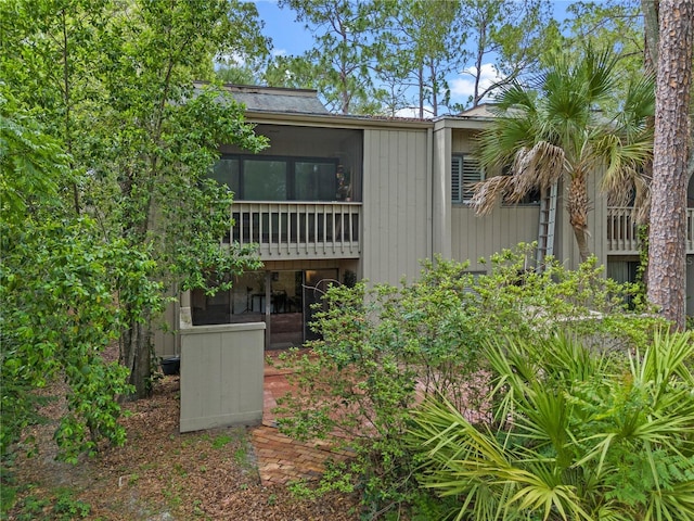 111 Crown Oaks Way Unit 101, Longwood, FL 32779 - rear view of property with a sunroom
