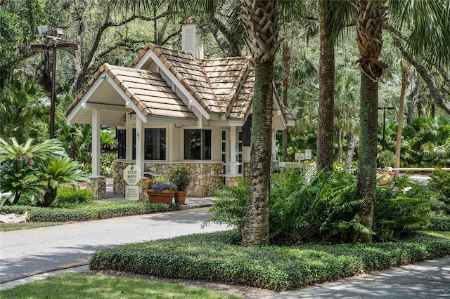 111 Crown Oaks Way Unit 101, Longwood, FL 32779 - view of front of house featuring stone siding and a chimney