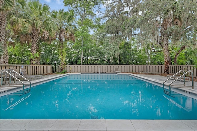 111 Crown Oaks Way Unit 101, Longwood, FL 32779 - community pool with view of wooded area, a fenced backyard, and a patio