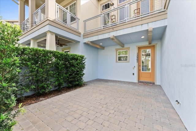 13865 Granger Ave, Orlando, FL 32827 - property entrance featuring a ceiling fan, a balcony, a patio area, and stucco siding