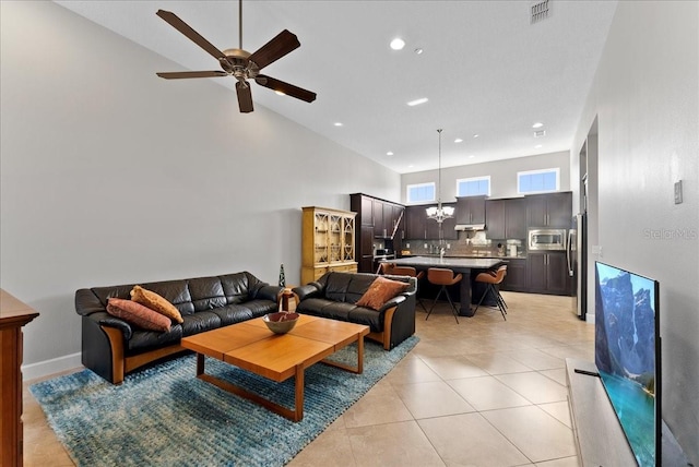13865 Granger Ave, Orlando, FL 32827 - living room featuring visible vents, light tile patterned floors, high vaulted ceiling, ceiling fan with notable chandelier, and recessed lighting