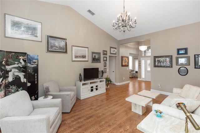 603 Yorkshire Dr, Oviedo, FL 32765 - living room with a chandelier, light wood finished floors, high vaulted ceiling, and baseboards
