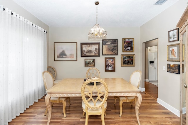 603 Yorkshire Dr, Oviedo, FL 32765 - dining space featuring light wood-style flooring, a chandelier, and baseboards