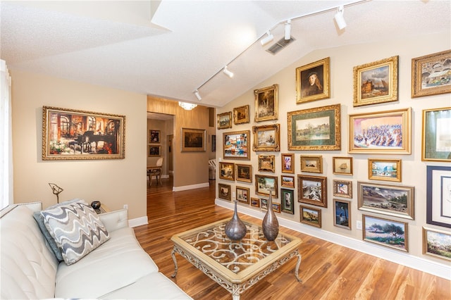 603 Yorkshire Dr, Oviedo, FL 32765 - living area with track lighting, wood finished floors, baseboards, and vaulted ceiling