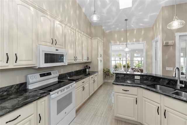 603 Yorkshire Dr, Oviedo, FL 32765 - kitchen featuring white appliances, a sink, hanging light fixtures, and dark stone counters