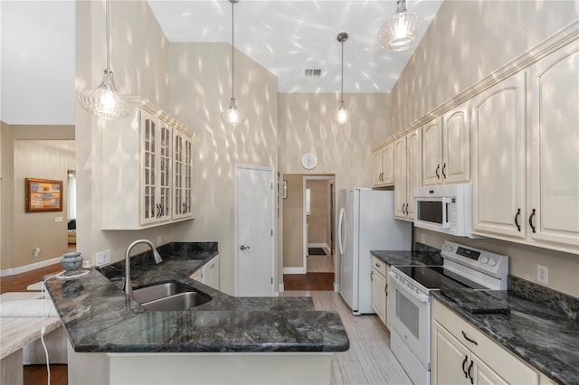 603 Yorkshire Dr, Oviedo, FL 32765 - kitchen featuring white appliances, a sink, glass insert cabinets, a peninsula, and a high ceiling