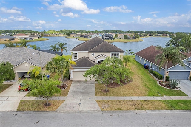 drone / aerial view with a water view and a residential view