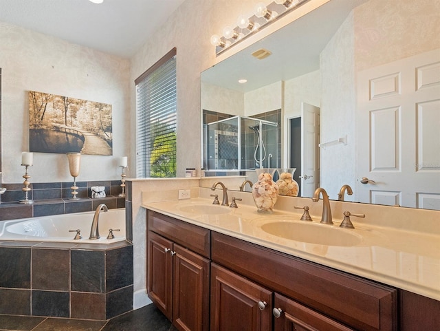bathroom with a sink, double vanity, a garden tub, and a shower stall