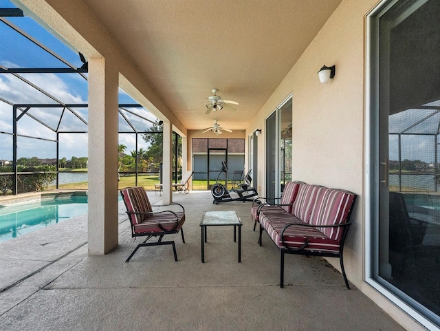 view of patio featuring a ceiling fan, glass enclosure, a water view, and an outdoor pool