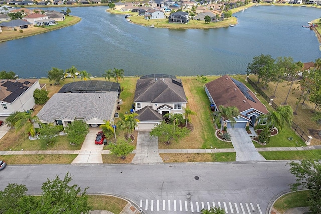 drone / aerial view featuring a water view and a residential view