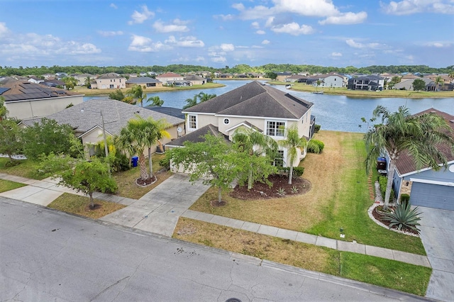drone / aerial view with a water view and a residential view