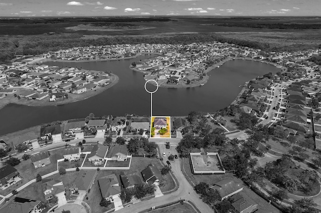 birds eye view of property with a water view and a residential view