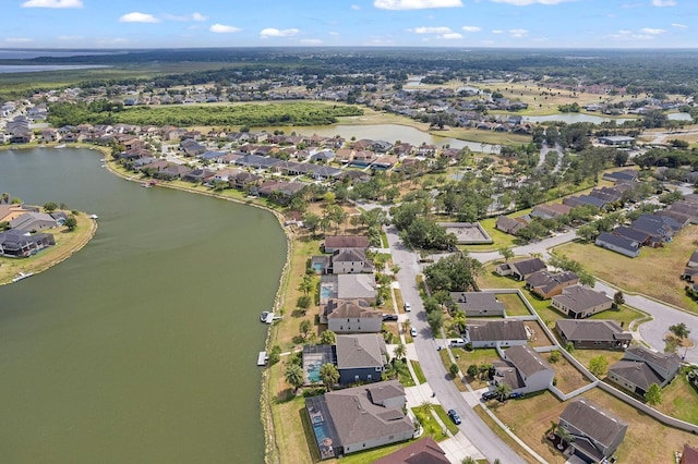 birds eye view of property featuring a water view and a residential view