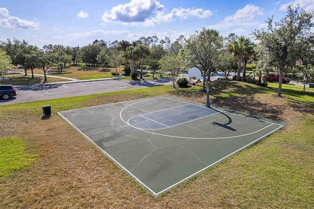 view of basketball court with community basketball court and a lawn