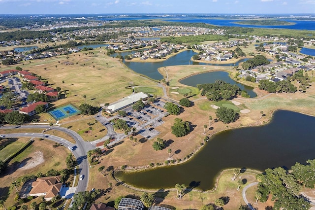 aerial view with golf course view, a water view, and a residential view