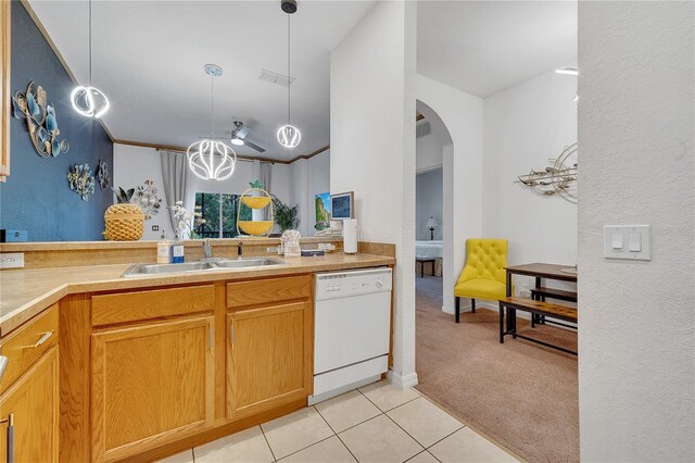 510 Rum Run Unit 33-510, Davenport, FL 33837 - kitchen with white dishwasher, a sink, arched walkways, light carpet, and light countertops