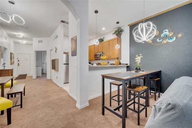 510 Rum Run Unit 33-510, Davenport, FL 33837 - dining space with a chandelier, arched walkways, light colored carpet, a textured wall, and baseboards