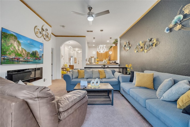 510 Rum Run Unit 33-510, Davenport, FL 33837 - living room featuring light colored carpet, ceiling fan, ornamental molding, arched walkways, and a textured wall