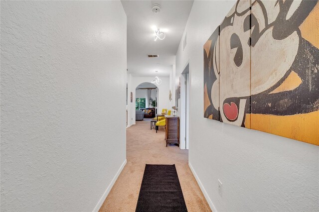 510 Rum Run Unit 33-510, Davenport, FL 33837 - corridor featuring arched walkways, carpet, a textured wall, and baseboards