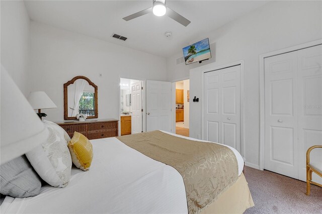 510 Rum Run Unit 33-510, Davenport, FL 33837 - bedroom with two closets, light colored carpet, ensuite bath, and a ceiling fan