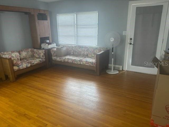 404 E Kentucky Ave, Deland, FL 32724 - living room with light wood finished floors and a fireplace