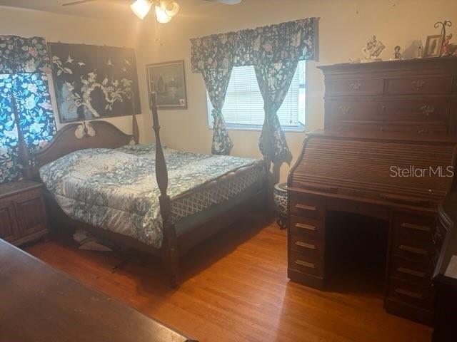 404 E Kentucky Ave, Deland, FL 32724 - bedroom featuring wood finished floors and a ceiling fan