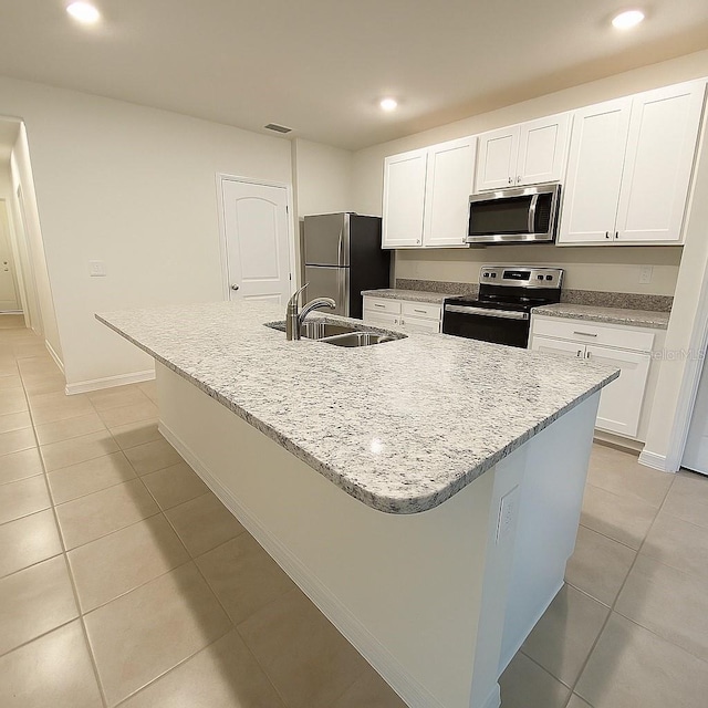 5216 Greenheart Ave, Mount Dora, FL 32757 - kitchen with white cabinets, light tile patterned floors, stainless steel appliances, and a sink