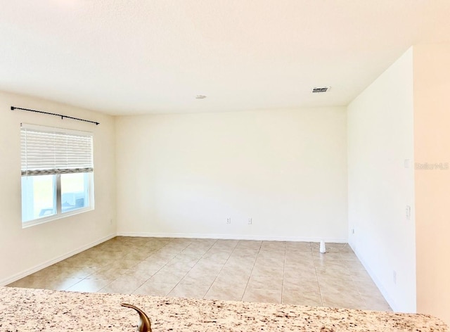 5216 Greenheart Ave, Mount Dora, FL 32757 - spare room featuring light tile patterned floors, visible vents, and baseboards