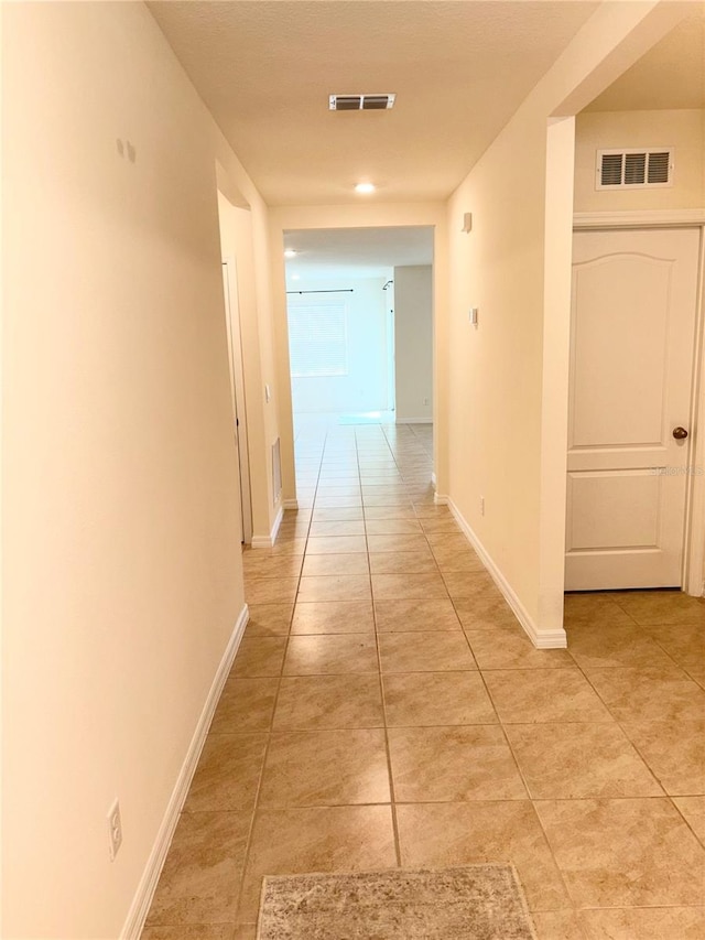 5216 Greenheart Ave, Mount Dora, FL 32757 - hallway with light tile patterned flooring, baseboards, and visible vents