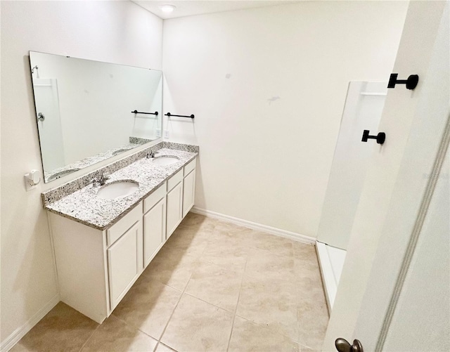 5216 Greenheart Ave, Mount Dora, FL 32757 - full bathroom featuring tile patterned floors, double vanity, baseboards, and a sink