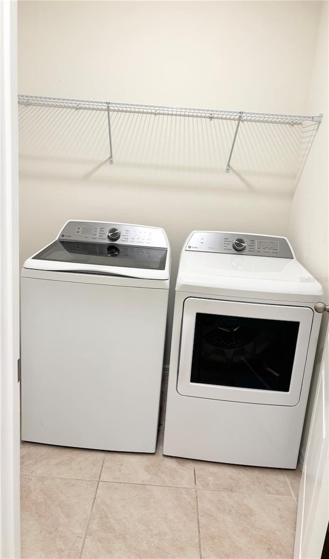 5216 Greenheart Ave, Mount Dora, FL 32757 - laundry area featuring laundry area, light tile patterned flooring, and washing machine and clothes dryer
