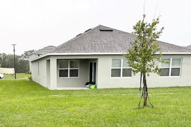 5216 Greenheart Ave, Mount Dora, FL 32757 - rear view of property with a yard, roof with shingles, and stucco siding