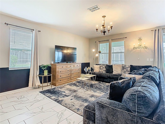 303 Ocean Course Ave, Davenport, FL 33896 - living area with a notable chandelier, visible vents, and marble finish floor