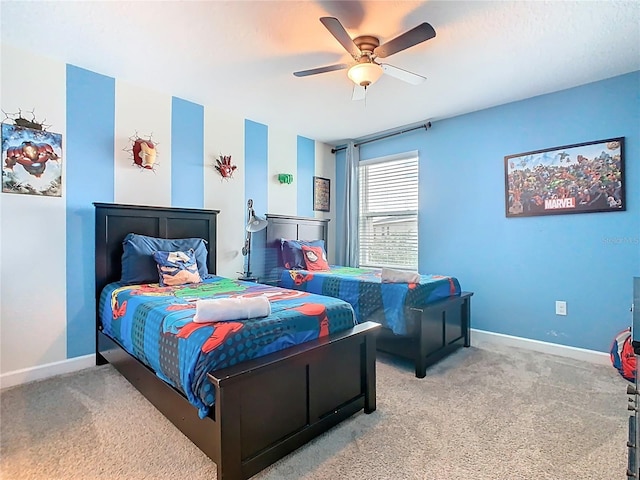303 Ocean Course Ave, Davenport, FL 33896 - bedroom with baseboards, ceiling fan, and carpet flooring