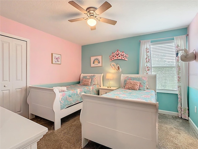 303 Ocean Course Ave, Davenport, FL 33896 - bedroom with carpet floors, ceiling fan, baseboards, and a closet