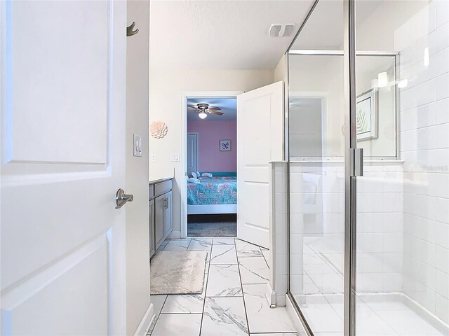 303 Ocean Course Ave, Davenport, FL 33896 - ensuite bathroom with ceiling fan, visible vents, a shower stall, marble finish floor, and ensuite bath