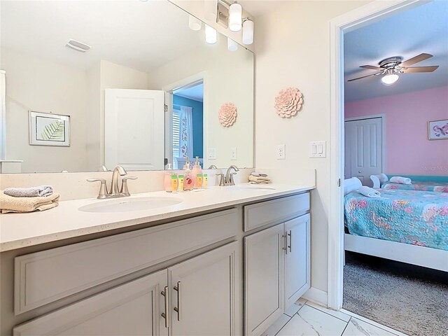 303 Ocean Course Ave, Davenport, FL 33896 - ensuite bathroom featuring a sink, a ceiling fan, double vanity, and connected bathroom