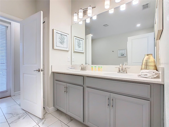 303 Ocean Course Ave, Davenport, FL 33896 - bathroom featuring double vanity, visible vents, a sink, and marble finish floor
