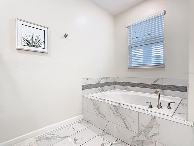 303 Ocean Course Ave, Davenport, FL 33896 - bathroom with baseboards, marble finish floor, and a bath