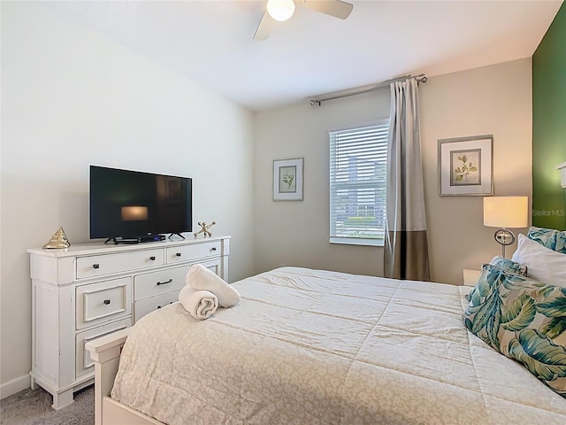 303 Ocean Course Ave, Davenport, FL 33896 - bedroom with baseboards, ceiling fan, and light carpet