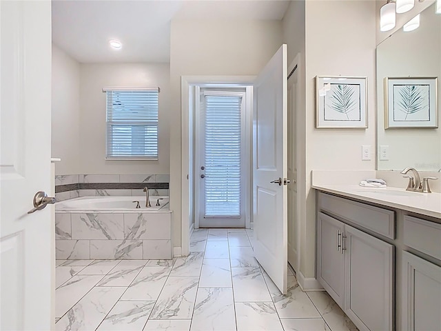303 Ocean Course Ave, Davenport, FL 33896 - full bath featuring vanity, baseboards, a bath, and marble finish floor
