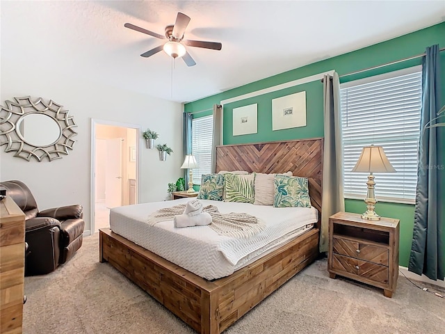 303 Ocean Course Ave, Davenport, FL 33896 - bedroom with ensuite bathroom, light carpet, and a ceiling fan