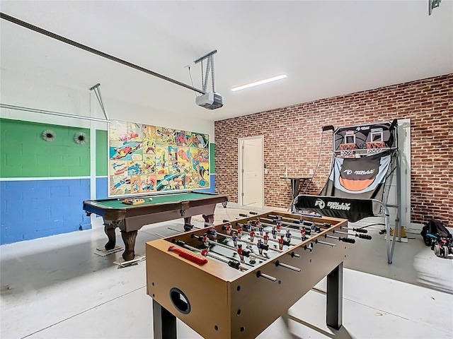 303 Ocean Course Ave, Davenport, FL 33896 - recreation room with a garage, billiards, concrete flooring, and brick wall