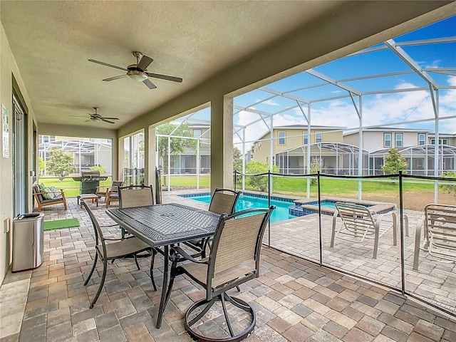 303 Ocean Course Ave, Davenport, FL 33896 - view of patio featuring ceiling fan, a pool with connected hot tub, glass enclosure, and outdoor dining space