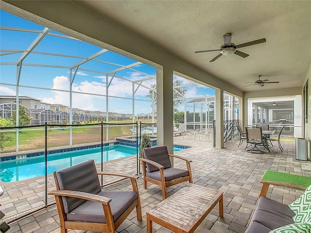 303 Ocean Course Ave, Davenport, FL 33896 - view of patio / terrace featuring glass enclosure, ceiling fan, a pool with connected hot tub, and outdoor dining space