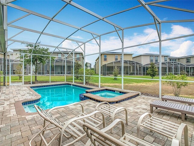 303 Ocean Course Ave, Davenport, FL 33896 - view of swimming pool featuring a lawn, a patio, and glass enclosure