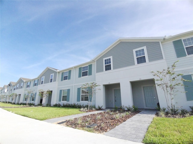 197 Jetty Way, Davenport, FL 33897 - townhome / multi-family property with a front lawn and stucco siding