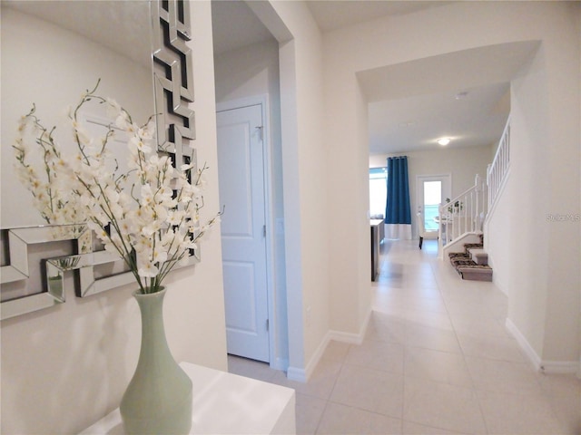 197 Jetty Way, Davenport, FL 33897 - hall featuring baseboards, light tile patterned flooring, and stairs