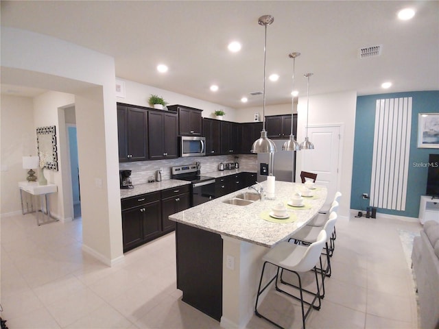 197 Jetty Way, Davenport, FL 33897 - kitchen with appliances with stainless steel finishes, tasteful backsplash, baseboards, a sink, and recessed lighting